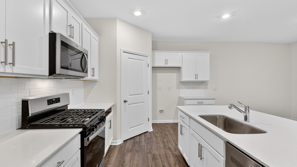 Kitchen with white cabinets and stainless steel appliances.
