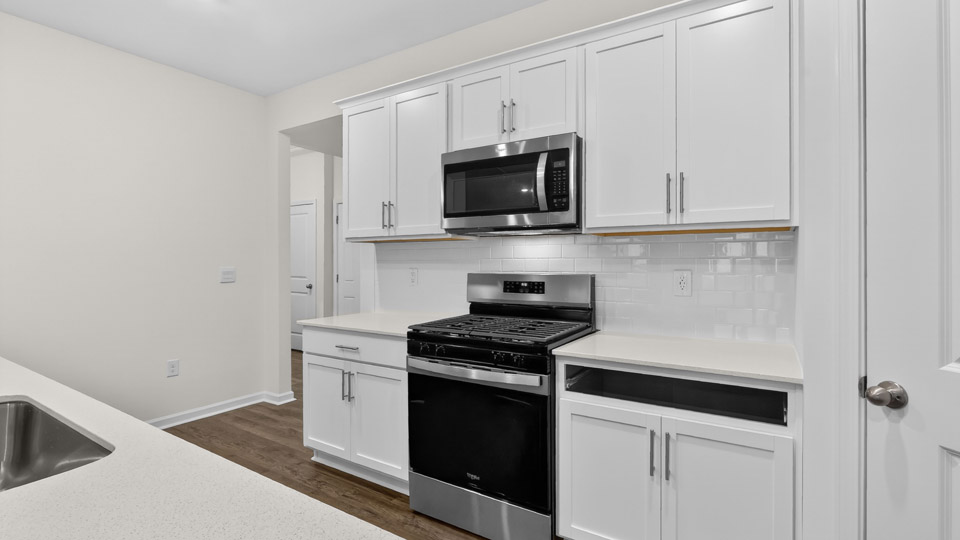 Kitchen with white cabinets and stainless steel appliances.