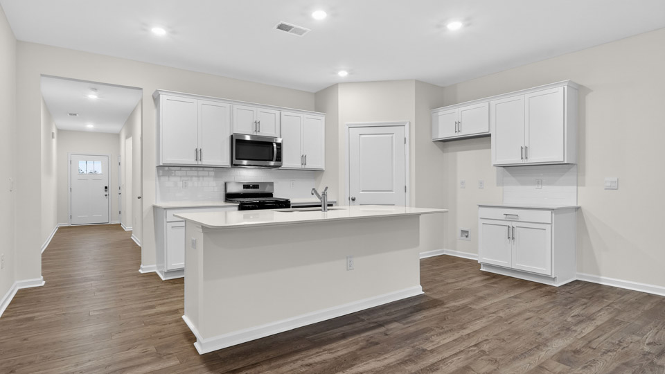 Kitchen with white cabinets and stainless steel appliances.