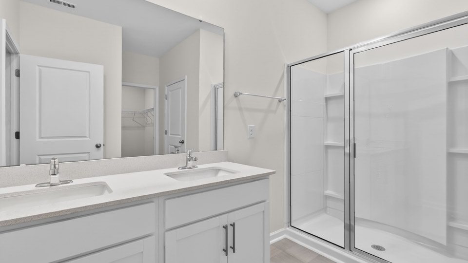 Primary bathroom with double sink and walk-in shower
