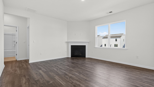 living room with revwood flooring and fireplace