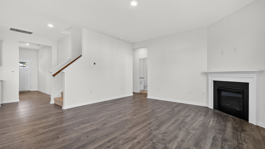 living room with revwood flooring and fireplace