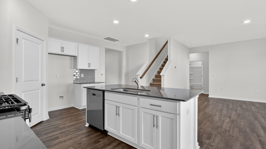 kitchen island with dishwasher and quartz countertops