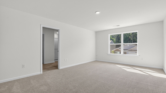 primary bedroom with carpet flooring
