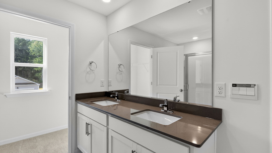bathroom with quartz countertops and dual vanity