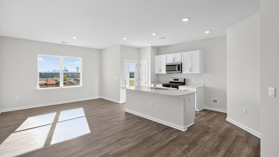 kitchen overlooking dining and living rooms with revwood flooring