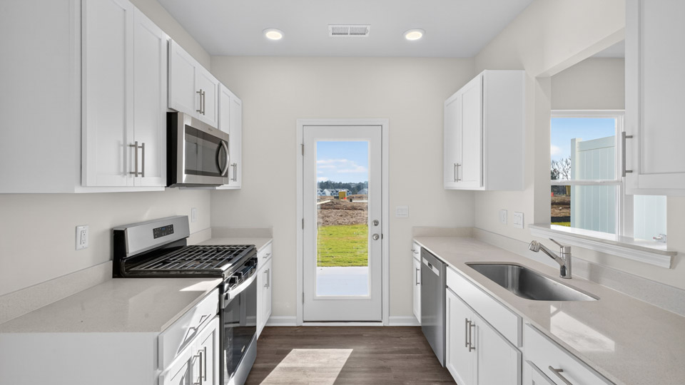 kitchen with white cabinets quartz countertops and stainless steel appliances