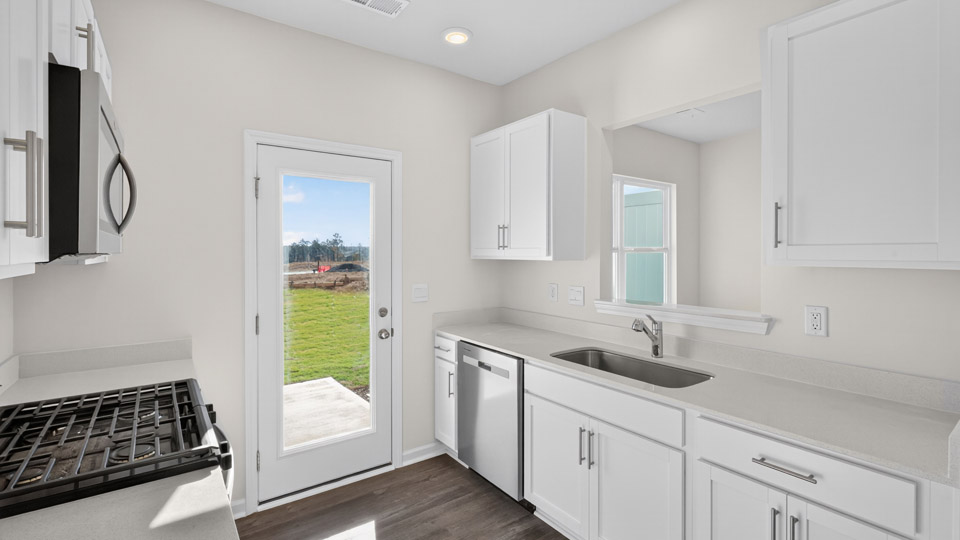 kitchen with white cabinets quartz countertops and stainless steel appliances