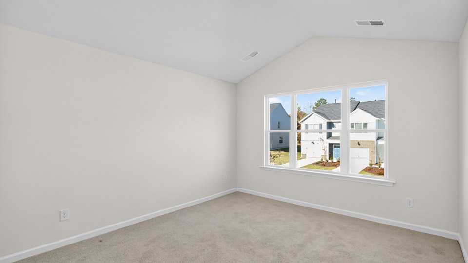 bedroom with carpet flooring and vaulted ceiling