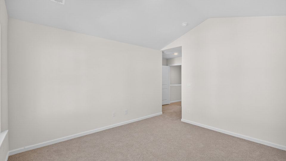 bedroom with carpet flooring and vaulted ceiling