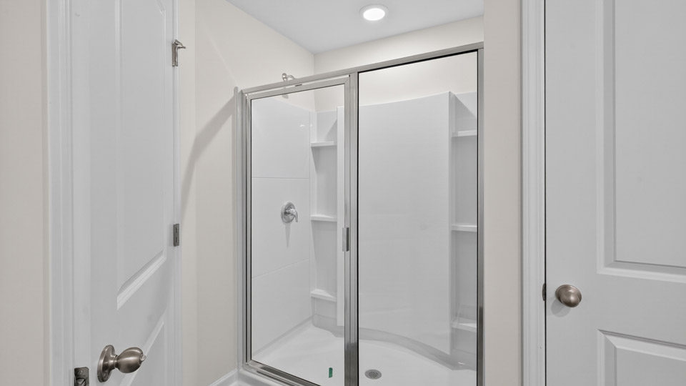 bathroom with walk-in shower with glass doors