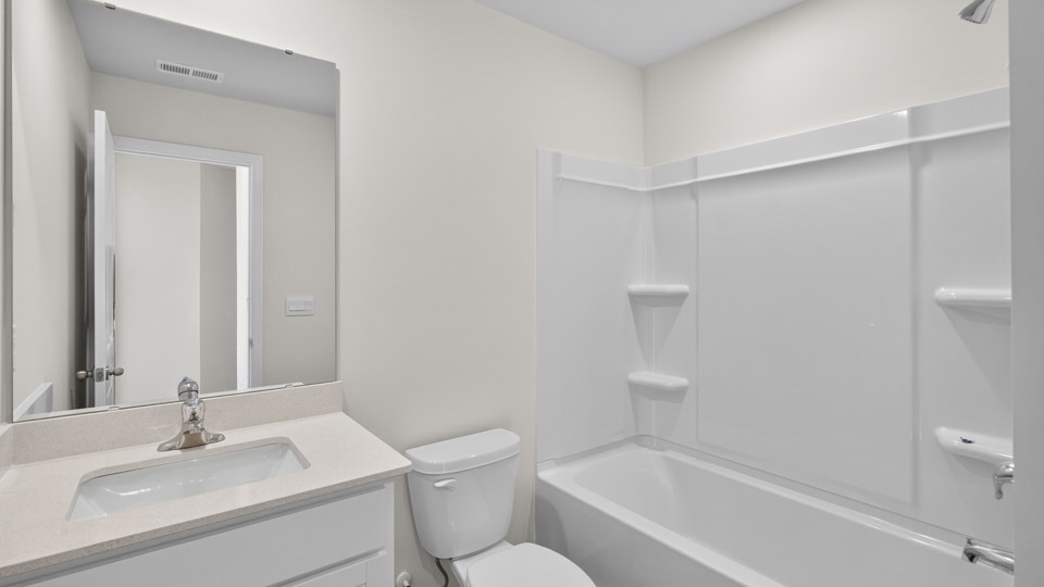 bathroom with quartz countertops and tub shower combo