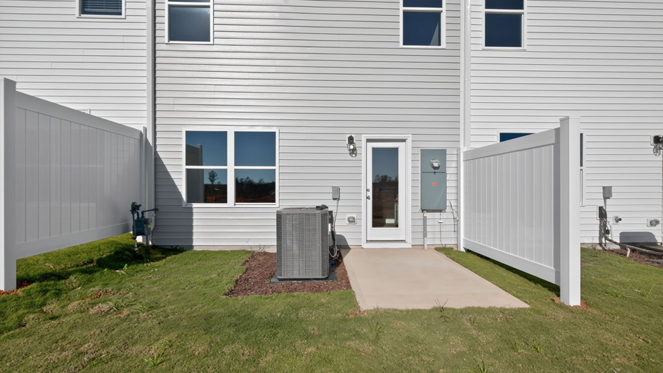 backyard with concrete patio and privacy fence on both sides