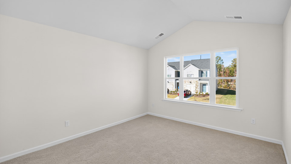 bedroom with carpet flooring and vaulted ceiling