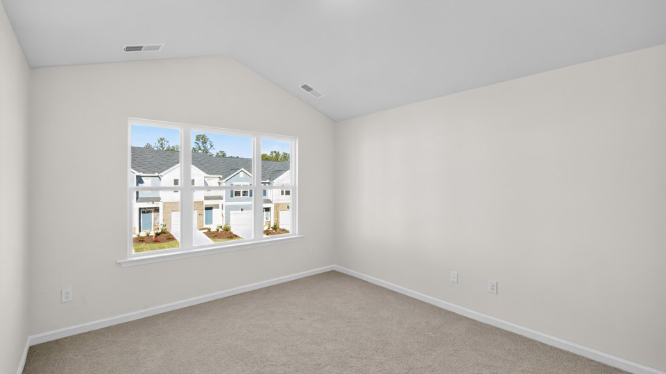 bedroom with carpet flooring and vaulted ceiling