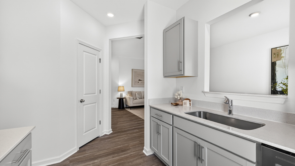 kitchen with quartz counters, kitchen island, pantry, stainless steel appliances