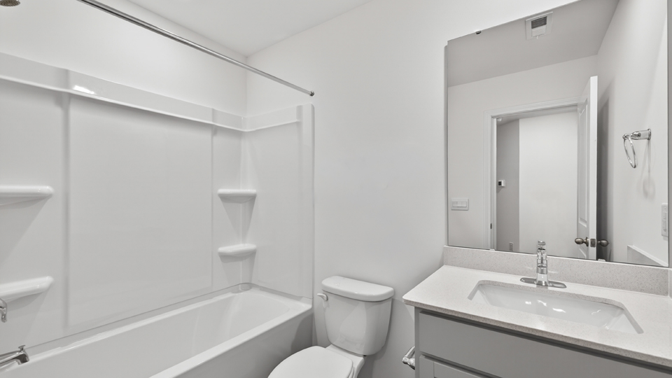 secondary bathroom with shower tub combo and single vanity sink
