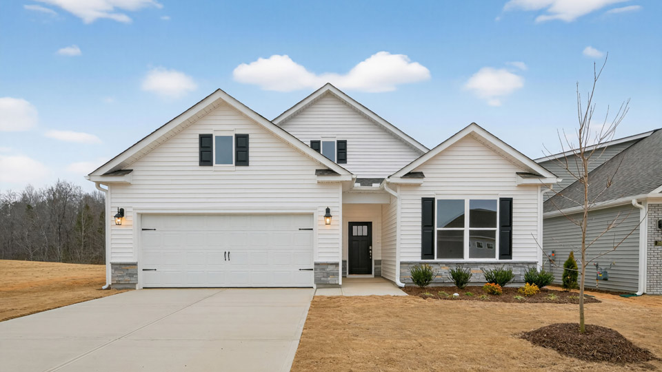 Two story home with white colored siding with a two car garage