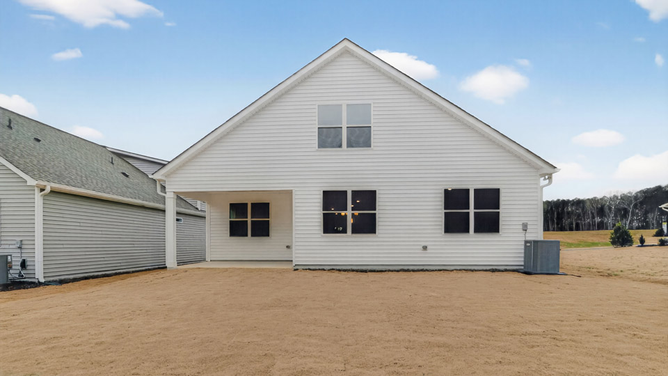 Two story home with white colored siding and view of backyard