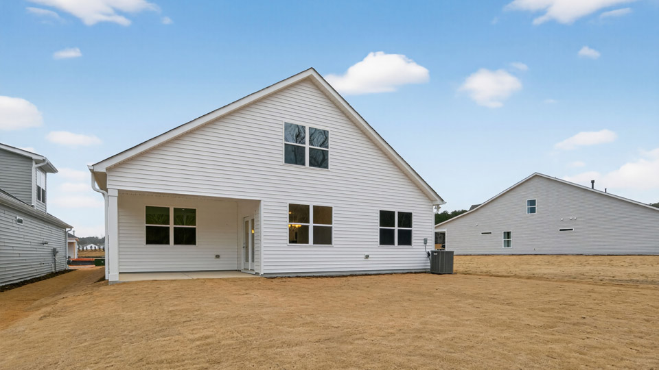 Two story home with white colored siding with view of backyard
