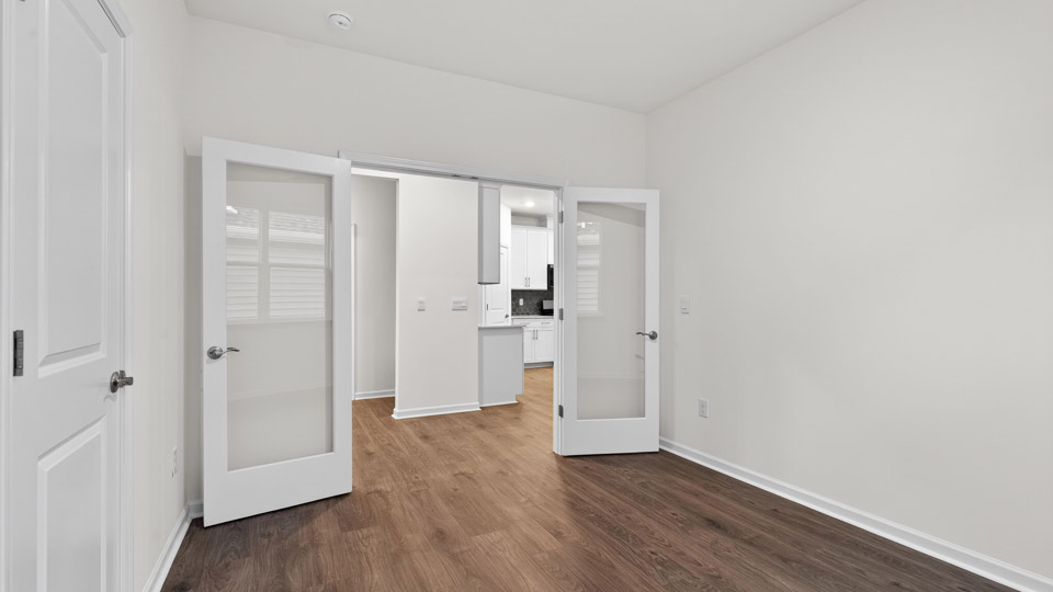 Study room with hardwood floors and big windows
