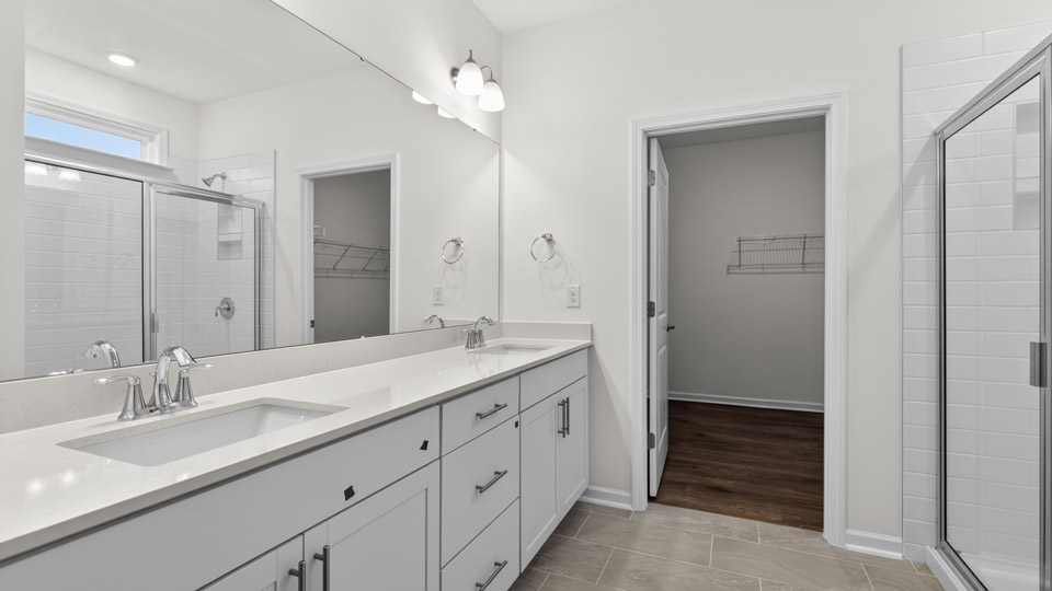 Primary bathroom with double sink and walk-in shower