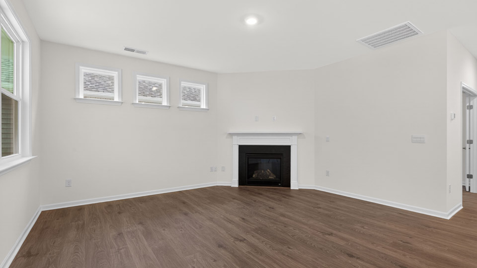 Open-concept living room with hardwood floors & fireplace