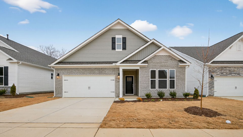 Two story home with gray colored siding with a two car garage