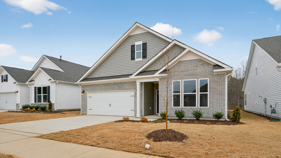 Two story home with gray colored siding with a two car garage