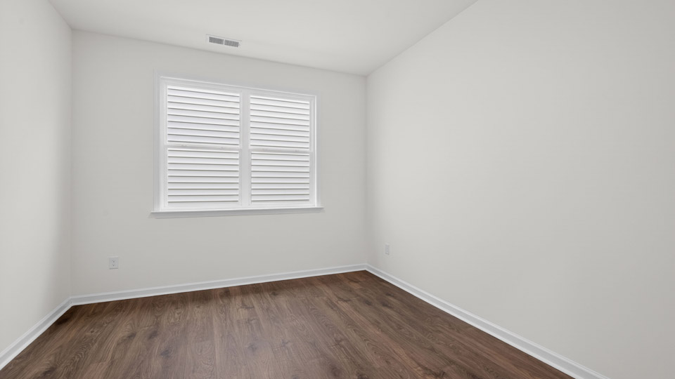 Bedroom with hardwood floor and closet