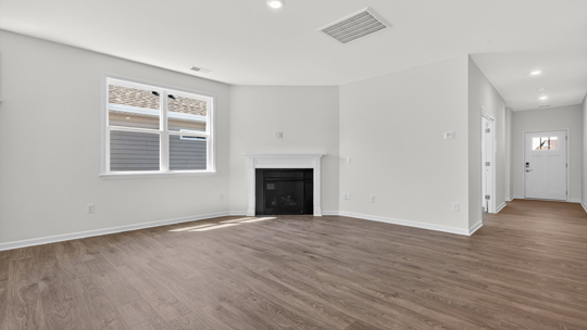 living room with fireplace and revwood flooring