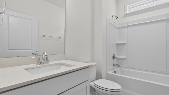 bathroom with quartz countertops and tub shower combo