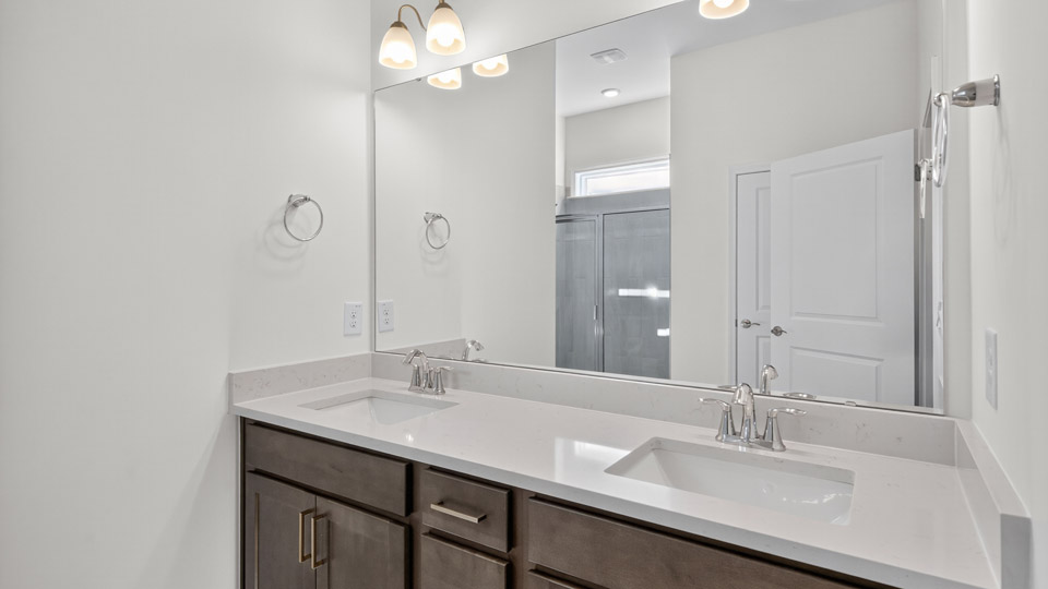 Primary bathroom with double sinks and quartz counters