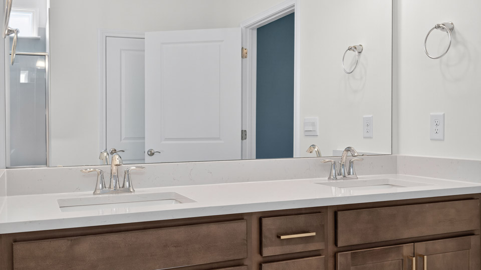 Primary bathroom with quartz counters and double sinks