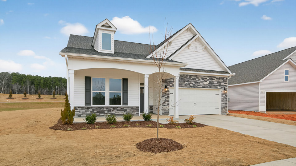Two story home with white colored siding with a two car garage