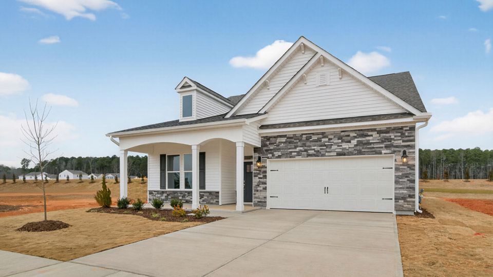 Two story home with white colored siding with a two car garage