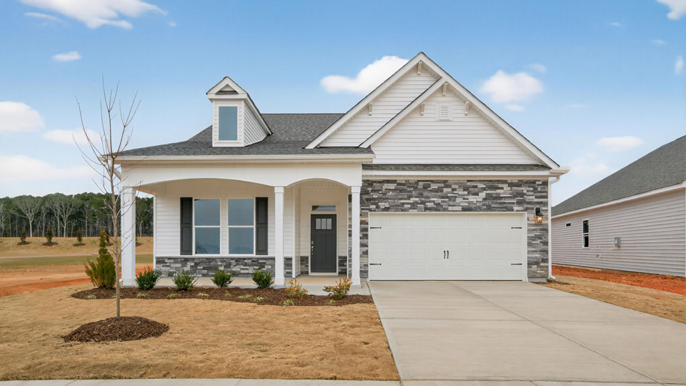Two story home with white colored siding with a two car garage