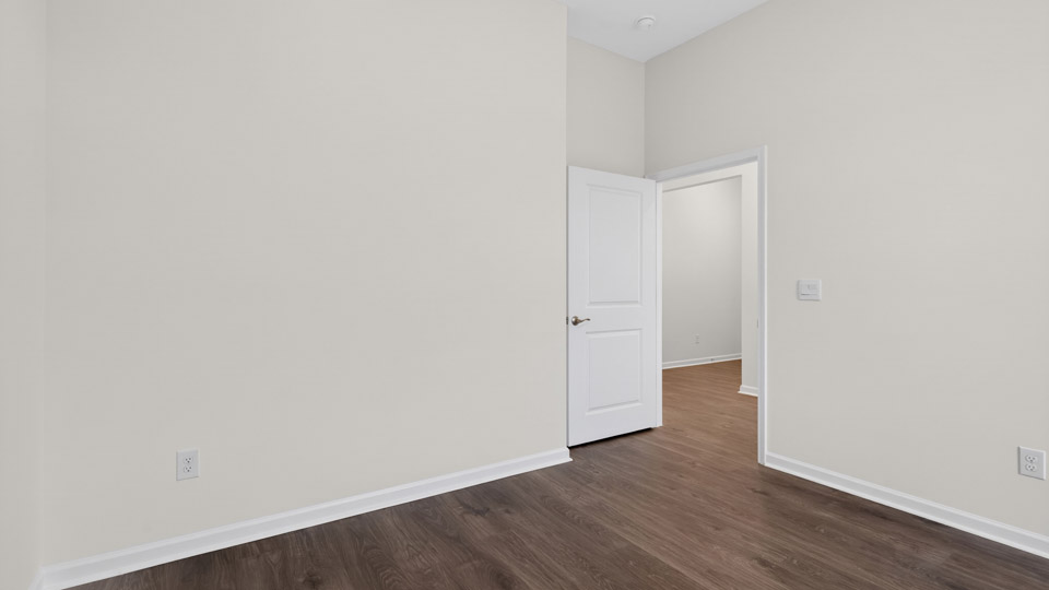 Bedroom with hardwood floor and closet