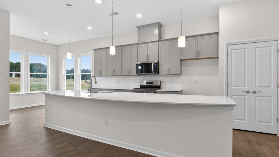 Kitchen with gray cabinets and stainless steel appliances.