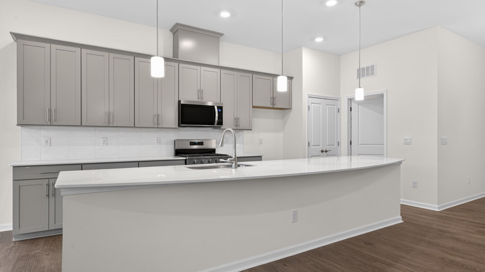 Kitchen with gray cabinets and stainless steel appliances.