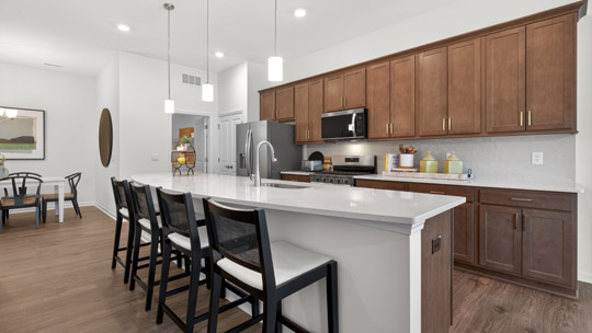 kitchen with brown cabinets and quartz countertops and kitchen island