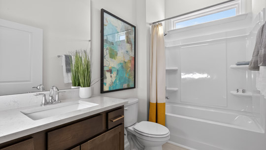 bathroom with tub shower combo and quartz countertops