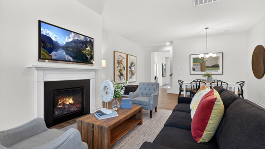 living room with fireplace and revwood flooring