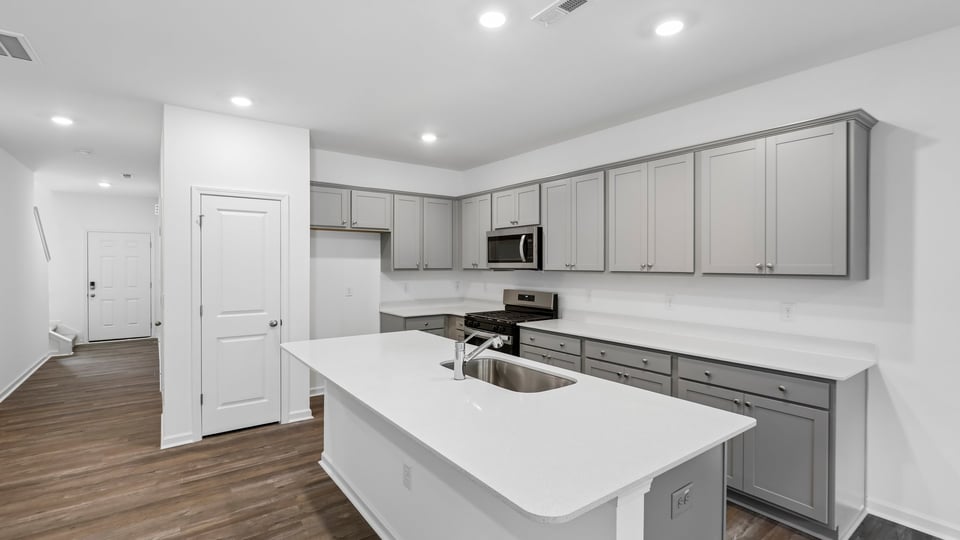 kitchen with gray cabinets quartz countertops and spacious island