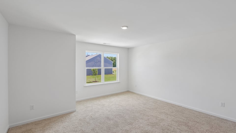 primary bedroom with carpet flooring