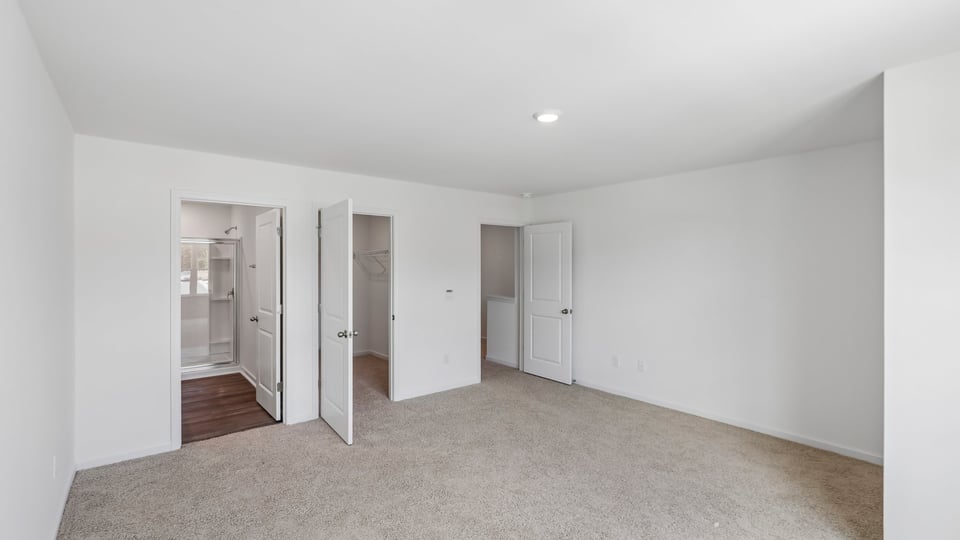 primary bedroom with carpet flooring