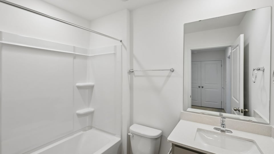 bathroom with quartz countertops and tub shower combo