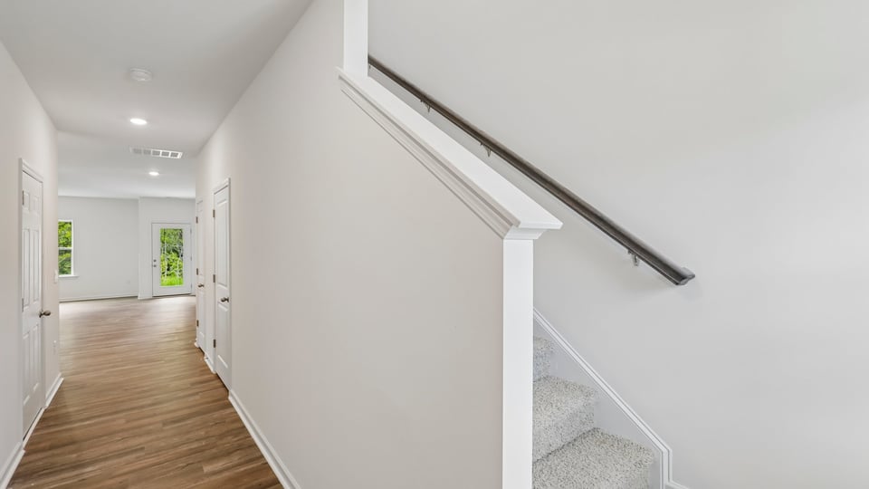 foyer entryway with carpeted staircase