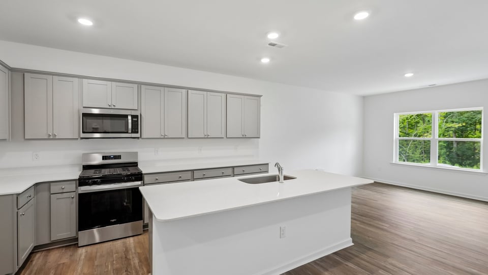 kitchen with gray cabinets quartz countertops and spacious island
