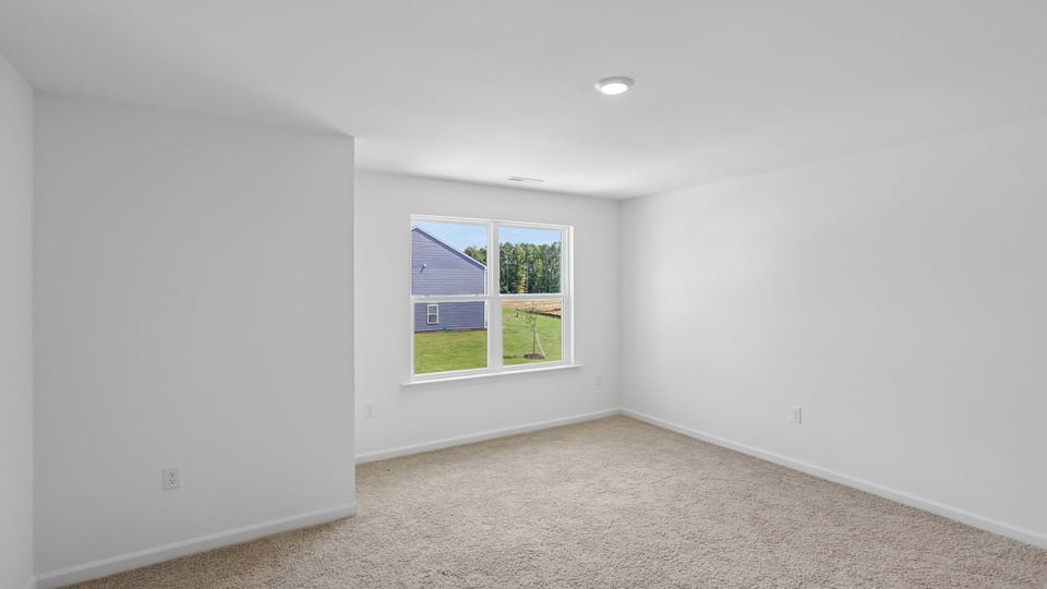 primary bedroom with carpet flooring